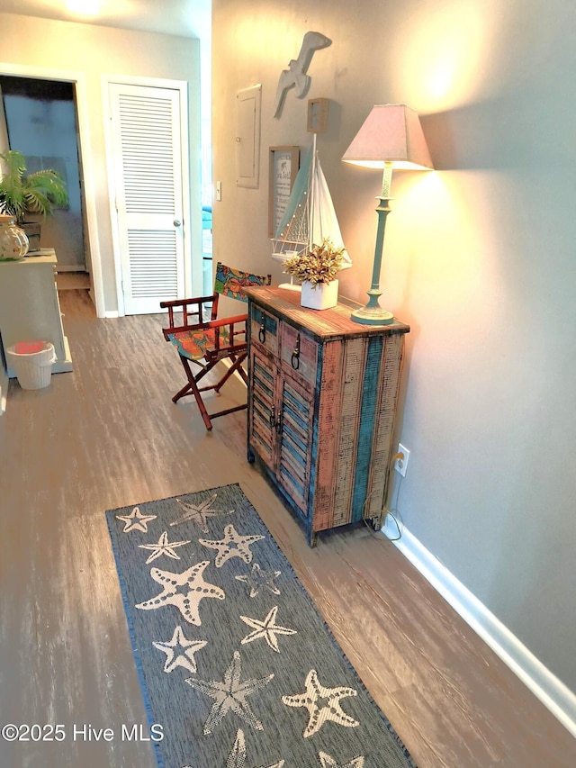 hallway with hardwood / wood-style floors and electric panel