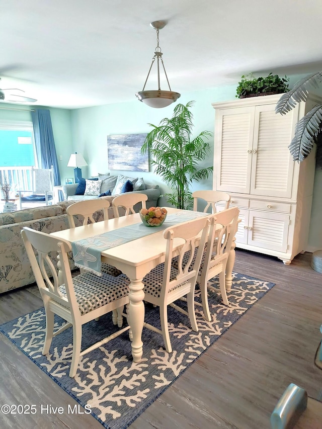 dining space with dark hardwood / wood-style floors