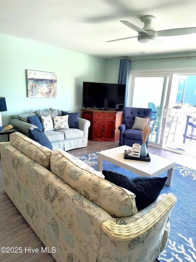 living room with wood-type flooring and ceiling fan