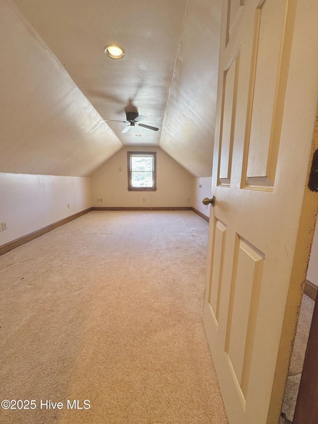 additional living space with vaulted ceiling and light colored carpet