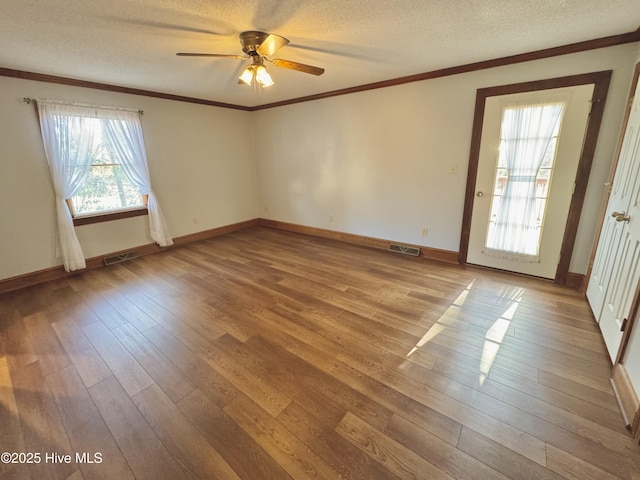 spare room with ceiling fan, crown molding, light hardwood / wood-style floors, and a textured ceiling