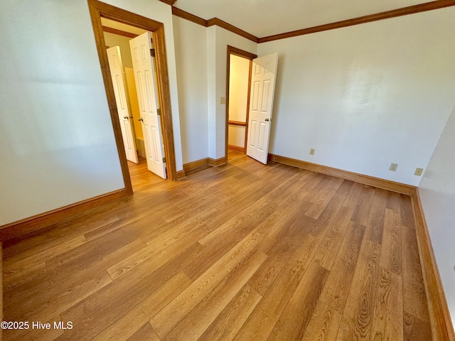 unfurnished bedroom featuring crown molding and light hardwood / wood-style floors