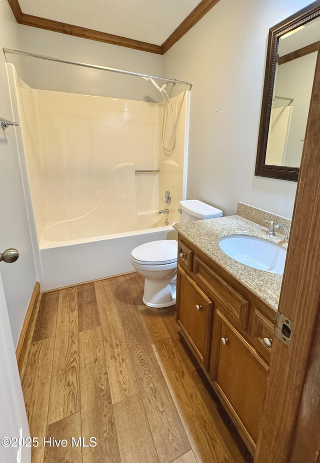 full bathroom with toilet, shower / bathtub combination, ornamental molding, vanity, and hardwood / wood-style flooring