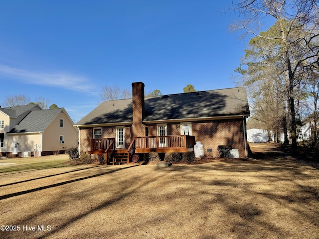 back of house with a lawn and a deck