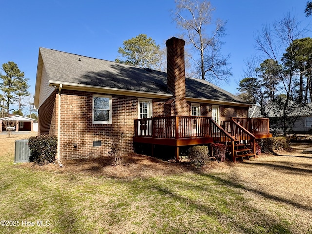 rear view of property featuring cooling unit, a yard, and a deck