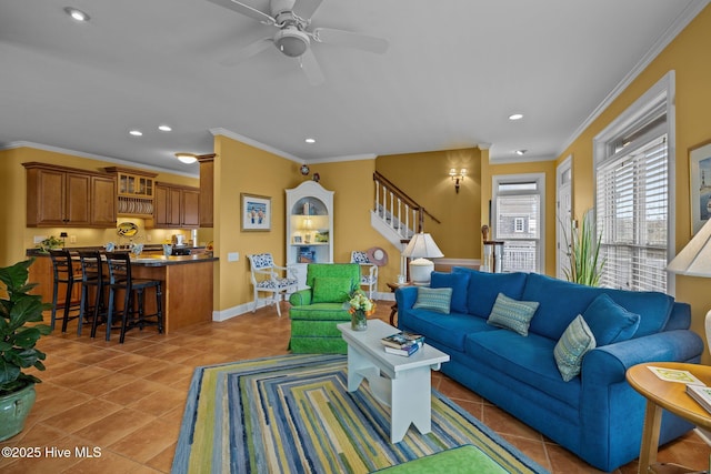 tiled living room featuring ornamental molding and ceiling fan