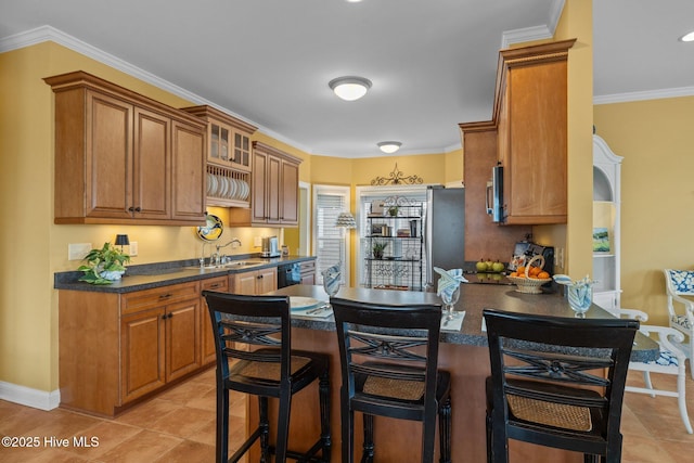 2208 Evans St, Morehead City, NC 28557 - kitchen featuring dark countertops, brown cabinets, stainless steel appliances, a kitchen breakfast bar, and crown molding