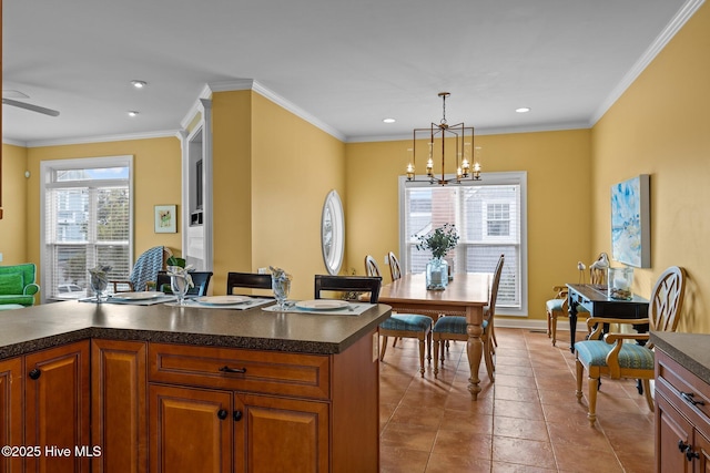 kitchen with hanging light fixtures, a notable chandelier, ornamental molding, and light tile patterned floors