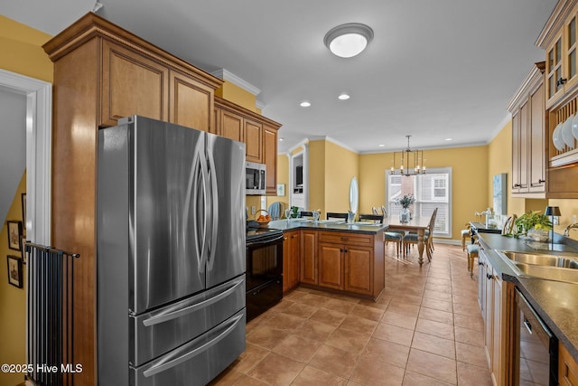 2208 Evans St, Morehead City, NC 28557 - kitchen featuring appliances with stainless steel finishes, dark countertops, brown cabinetry, ornamental molding, and a peninsula