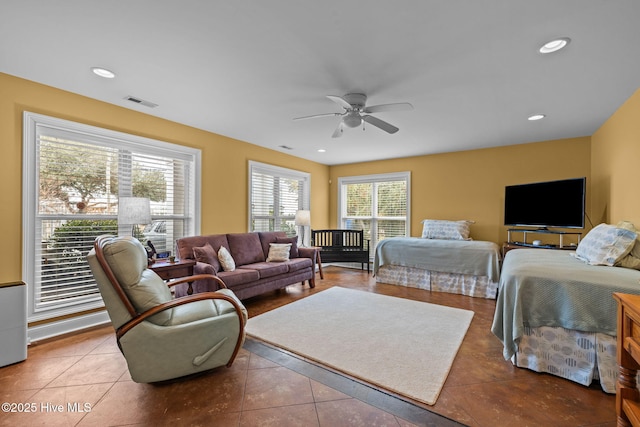 tiled bedroom featuring ceiling fan