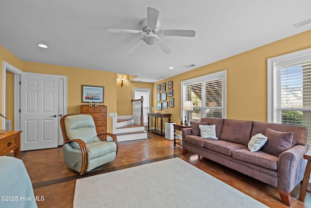 living room with a wealth of natural light and ceiling fan