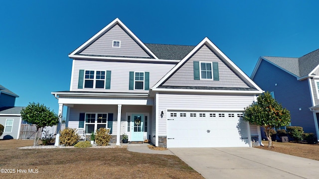 view of front facade featuring a porch, a garage, and a front yard