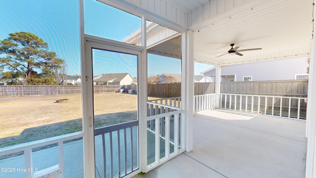 sunroom featuring ceiling fan