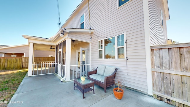 view of patio / terrace with a sunroom and ceiling fan