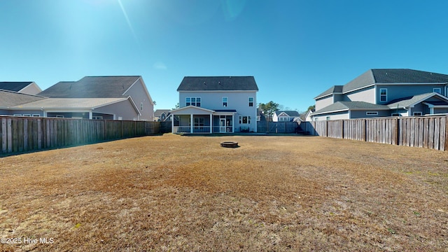 rear view of property with a lawn