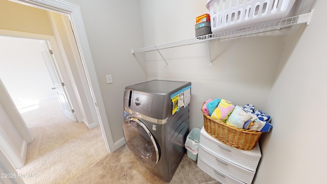 clothes washing area with washer / clothes dryer and light carpet