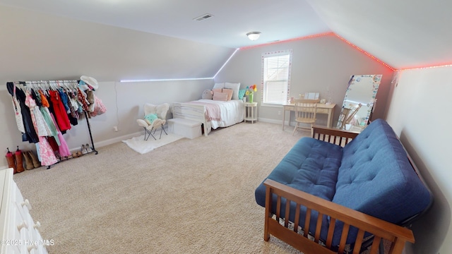 carpeted bedroom with lofted ceiling