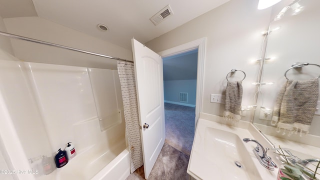 bathroom with vaulted ceiling, shower / tub combo with curtain, and vanity