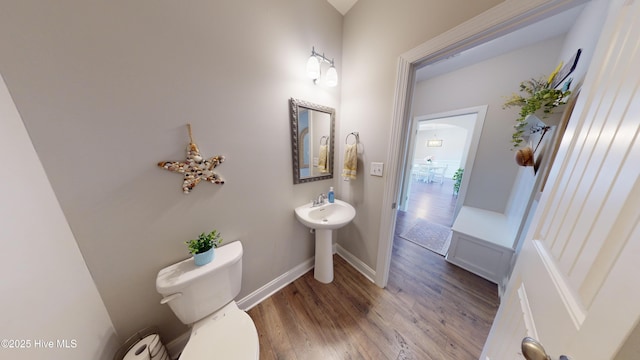 bathroom with wood-type flooring and toilet