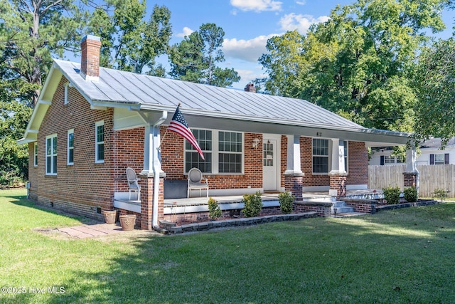 single story home featuring covered porch and a front lawn