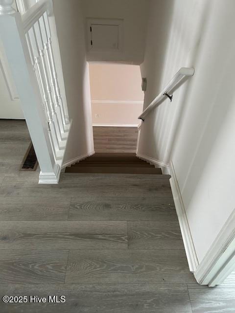 stairway featuring wood-type flooring