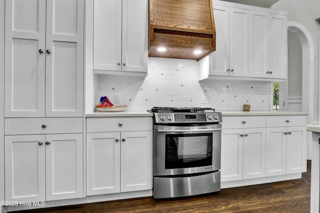 kitchen featuring premium range hood, white cabinets, dark hardwood / wood-style flooring, and stainless steel gas range oven