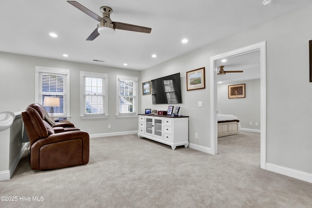 sitting room featuring ceiling fan and light colored carpet