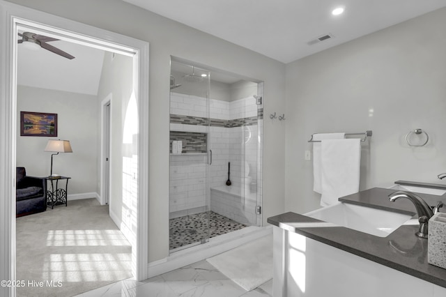 bathroom featuring walk in shower, ceiling fan, and vanity