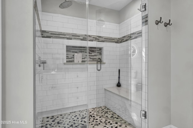 bathroom featuring a shower with door