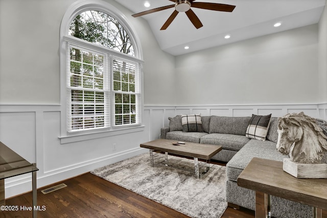 living room with lofted ceiling, dark hardwood / wood-style floors, and ceiling fan