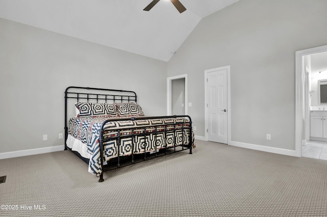 bedroom featuring light carpet, connected bathroom, high vaulted ceiling, and ceiling fan