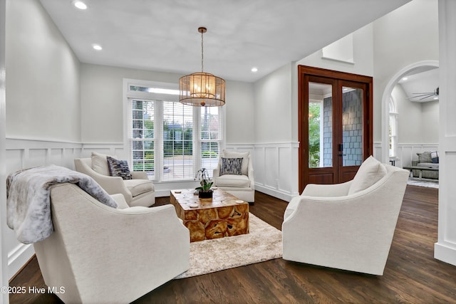 living room with french doors, dark hardwood / wood-style floors, and a notable chandelier