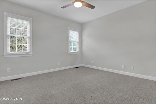 carpeted empty room with plenty of natural light and ceiling fan