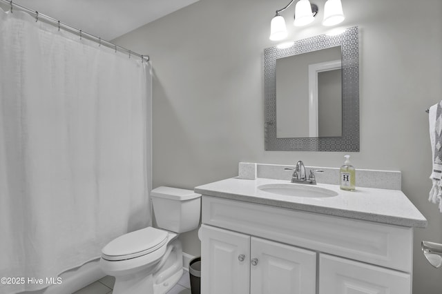 bathroom featuring vanity, curtained shower, and toilet