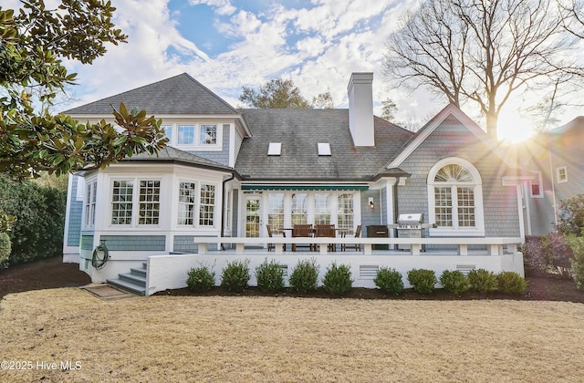 rear view of house with a yard