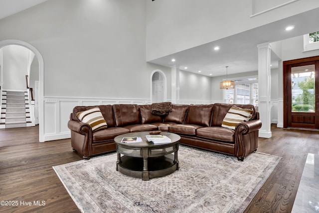 living room with dark hardwood / wood-style flooring and a high ceiling