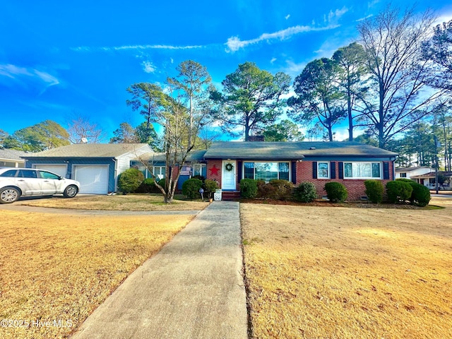 single story home with a garage and a front yard