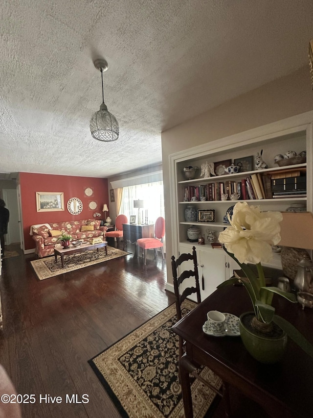 dining space featuring wood-type flooring and a textured ceiling