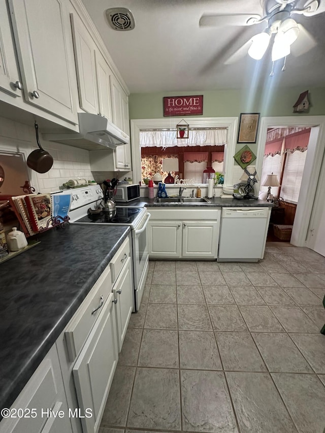 kitchen featuring white cabinetry, sink, backsplash, and white appliances