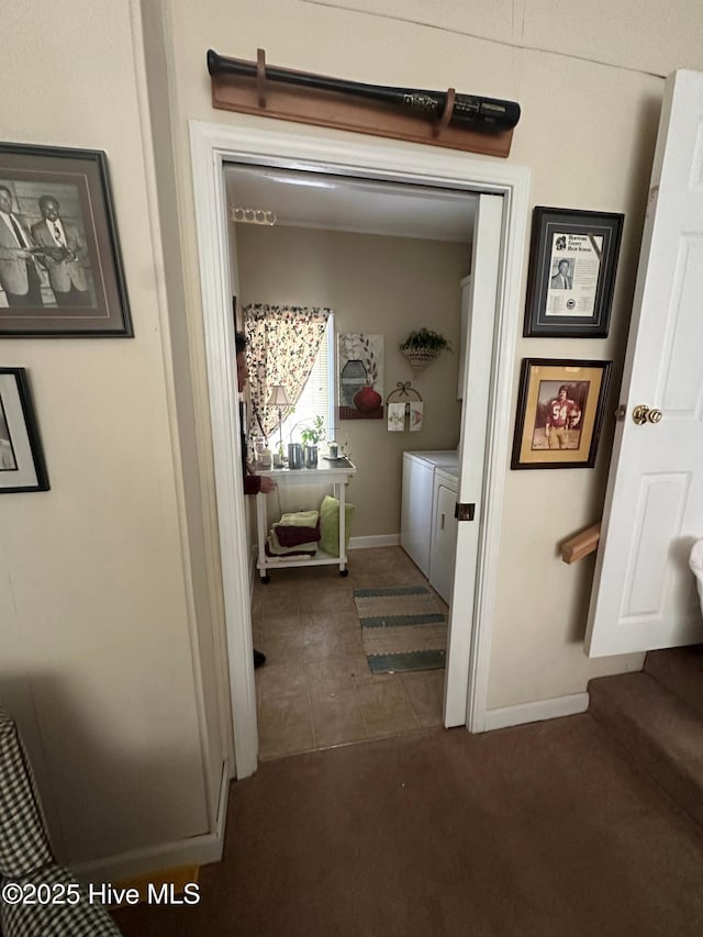 interior space featuring washer and clothes dryer and dark carpet