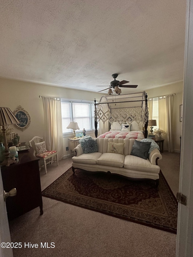 carpeted bedroom featuring ceiling fan and a textured ceiling