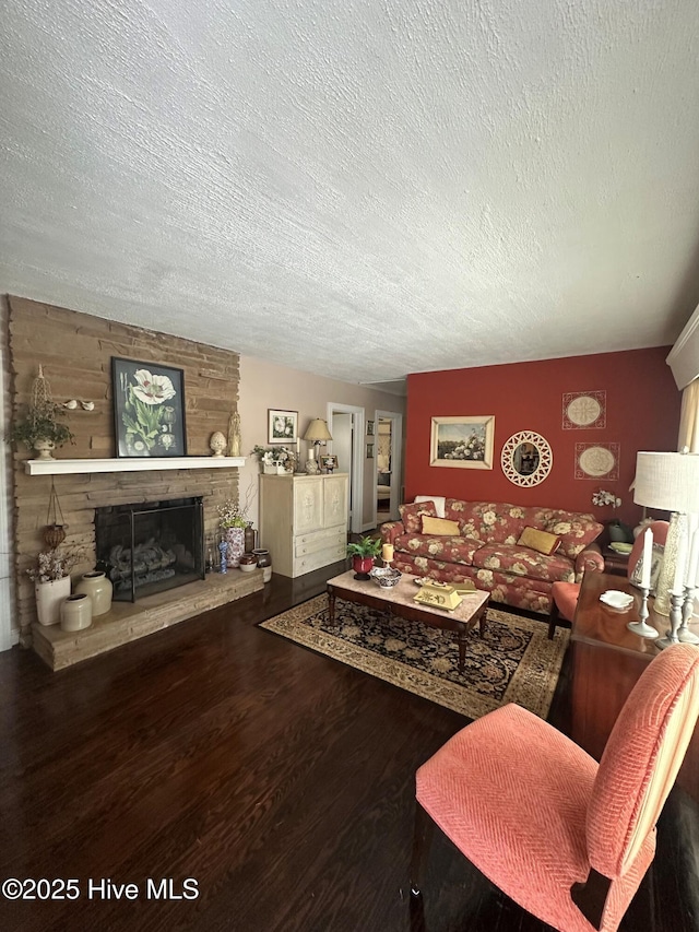 living room featuring a fireplace, hardwood / wood-style floors, and a textured ceiling