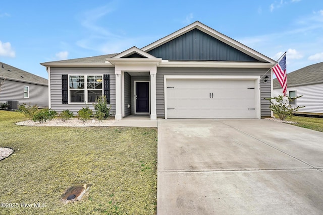 view of front of house with a garage, a front lawn, and central air condition unit