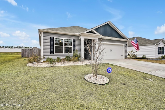 view of front of property featuring a garage and a front lawn