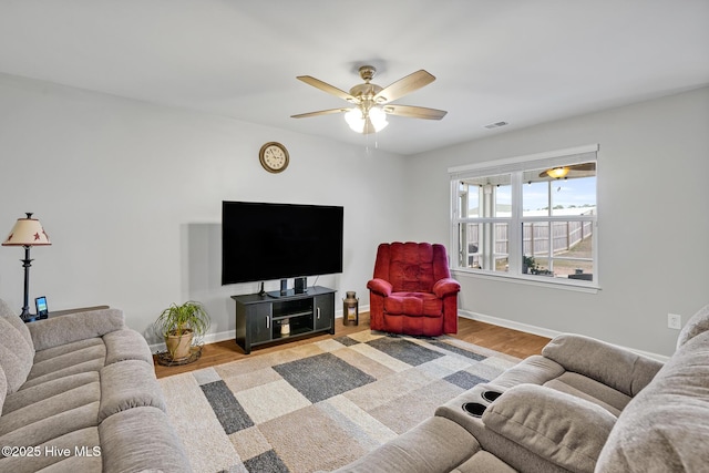 living room with light hardwood / wood-style floors and ceiling fan