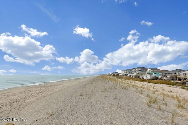 view of road with a view of the beach and a water view