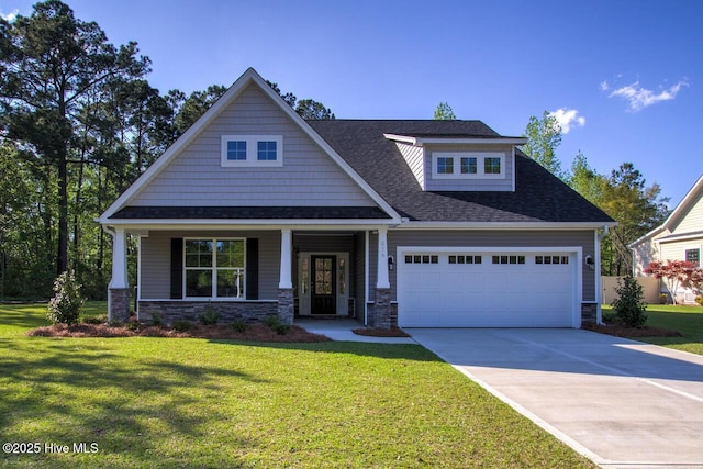 craftsman-style house featuring a garage, a front lawn, and covered porch