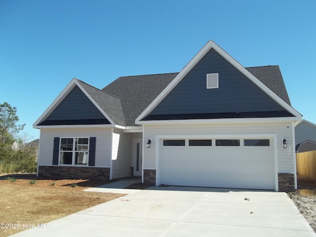 craftsman house with a garage, stone siding, roof with shingles, and concrete driveway