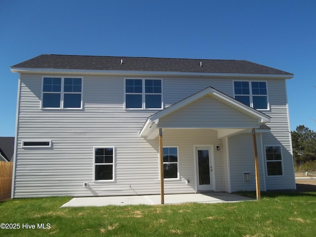 rear view of house featuring a patio and a lawn