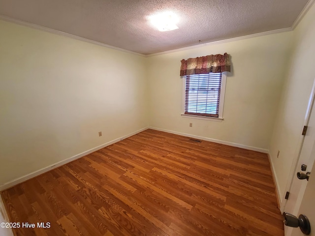 unfurnished room with crown molding, hardwood / wood-style floors, and a textured ceiling